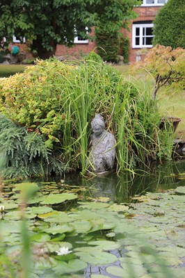 Lot 489 - A modern composite stone figure of a deity