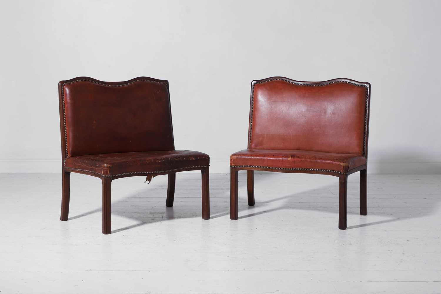 Lot 550 - A pair of walnut and leather hall benches