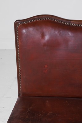 Lot 550 - A pair of walnut and leather hall benches