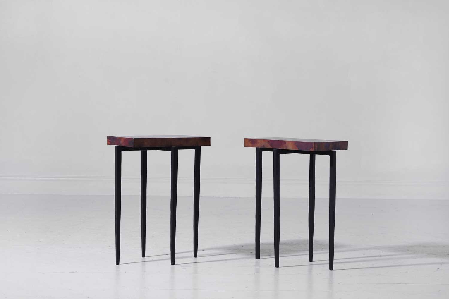 Lot 566 - A pair of modernist oxidised-copper and painted-metal occasional tables