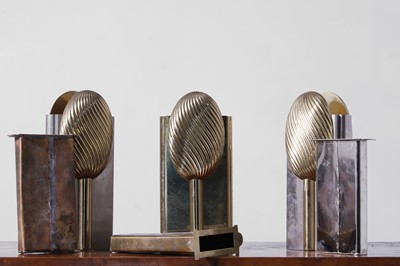 Lot 558 - A set of three nickel and brass vases