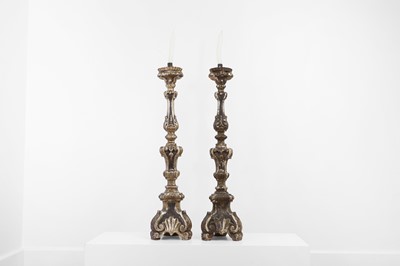 Lot 218 - A pair of silvered and giltwood altar candlesticks