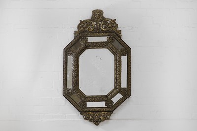 Lot 483 - A baroque-style repoussé brass wall mirror