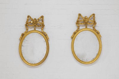 Lot 428 - A pair of neoclassical giltwood and gesso oval mirrors