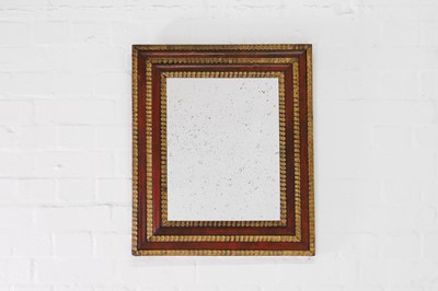Lot 257 - A red tortoiseshell and parcel-gilt wall mirror