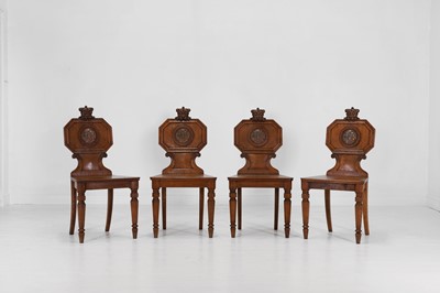 Lot 107 - A set of four William IV golden oak ducal hall chairs