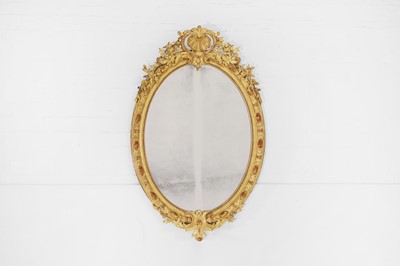 Lot 100 - A carved giltwood and gesso oval mirror