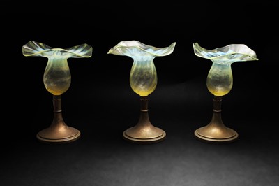Lot 162 - A group of three uranium green glass and pewter candle holders
