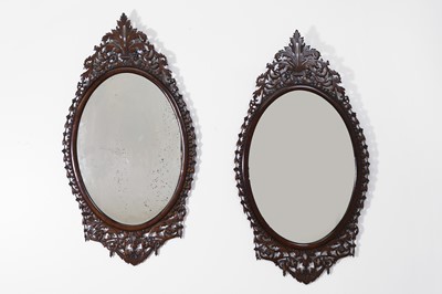 Lot 457 - A pair of George III-style mahogany wall mirrors