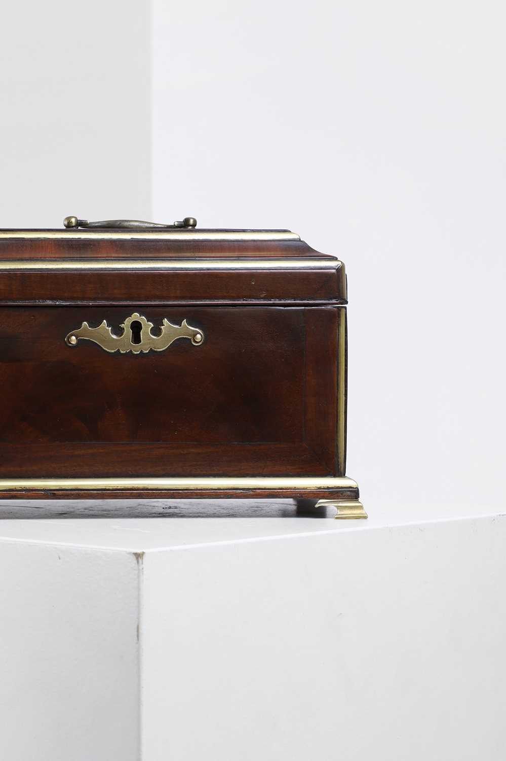 Lot A brass-mounted mahogany tea caddy in the manner of Abraham Roentgen