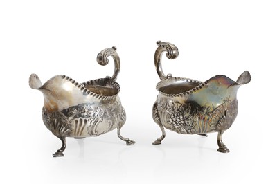 Lot 1 - A near pair of silver gravy boats