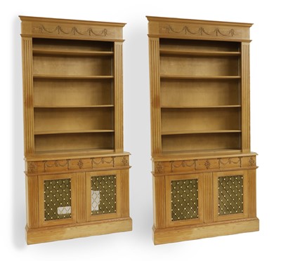 Lot 409 - A pair of neo-classical revival inverted lime wood breakfront bookcase
