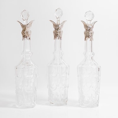 Lot 49 - A set of three silver-mounted cut-glass decanters