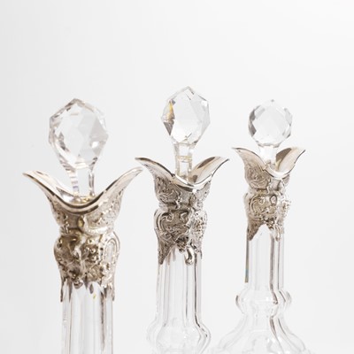 Lot 49 - A set of three silver-mounted cut-glass decanters