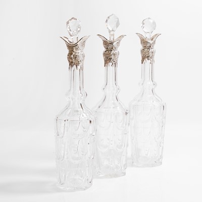 Lot 49 - A set of three silver-mounted cut-glass decanters