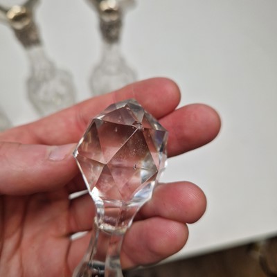 Lot 49 - A set of three silver-mounted cut-glass decanters