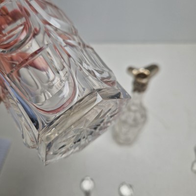 Lot 49 - A set of three silver-mounted cut-glass decanters