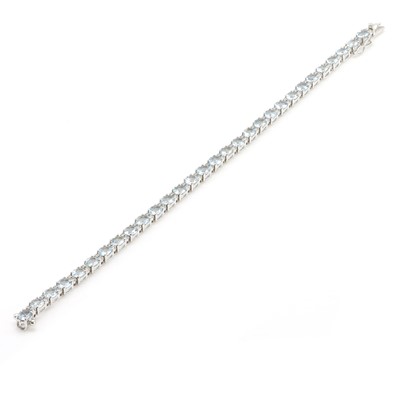 Lot 79 - An 18ct white gold aquamarine and diamond line bracelet