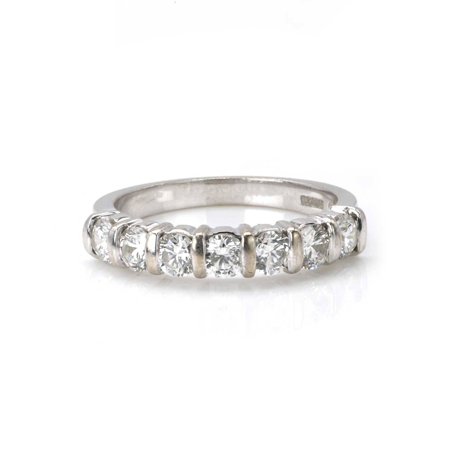 Lot 77 - An 18ct white gold diamond half eternity ring