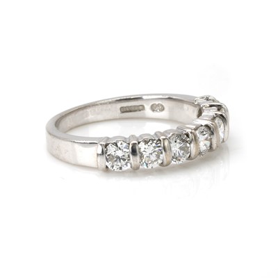 Lot 77 - An 18ct white gold diamond half eternity ring