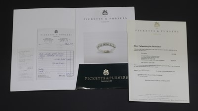 Lot 77 - An 18ct white gold diamond half eternity ring