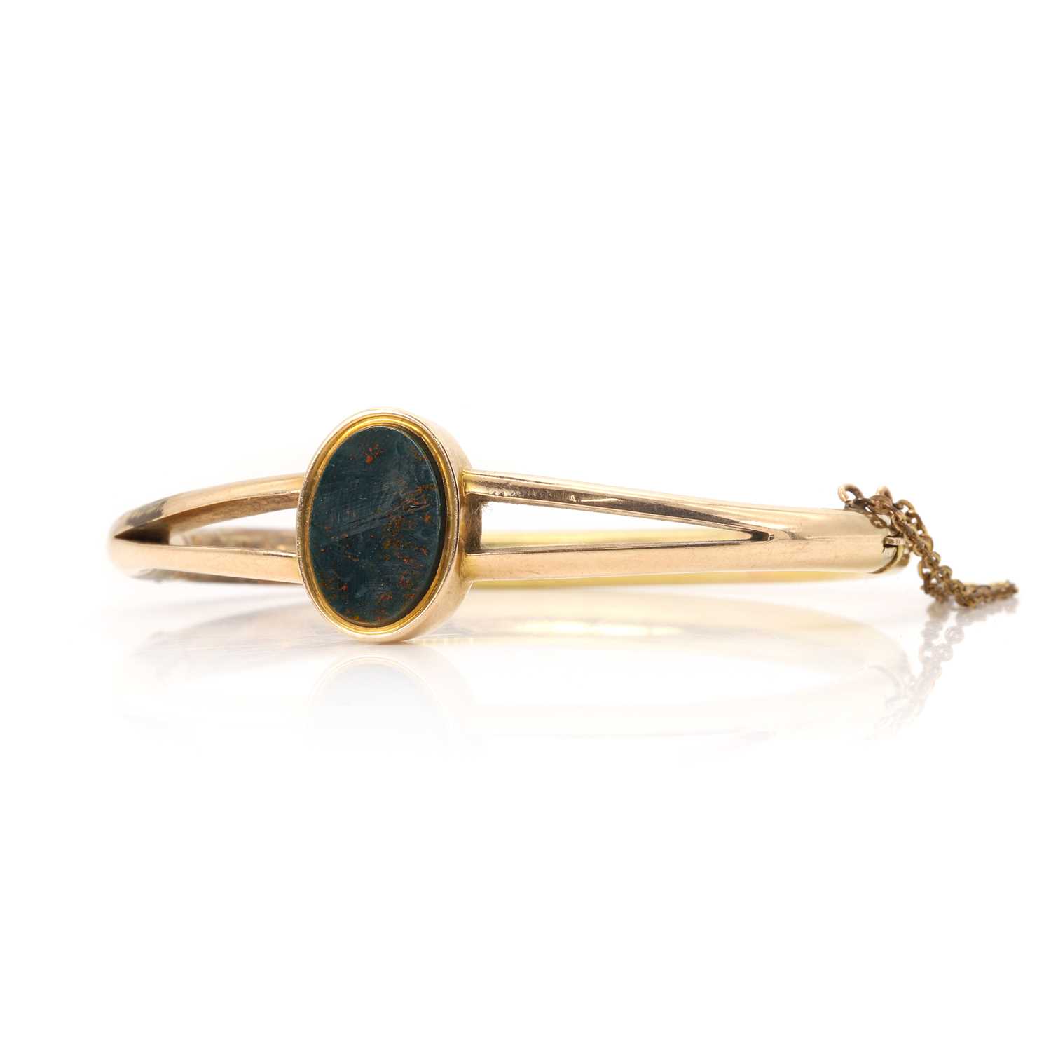 Lot 15 - A gold bloodstone set hinged bangle