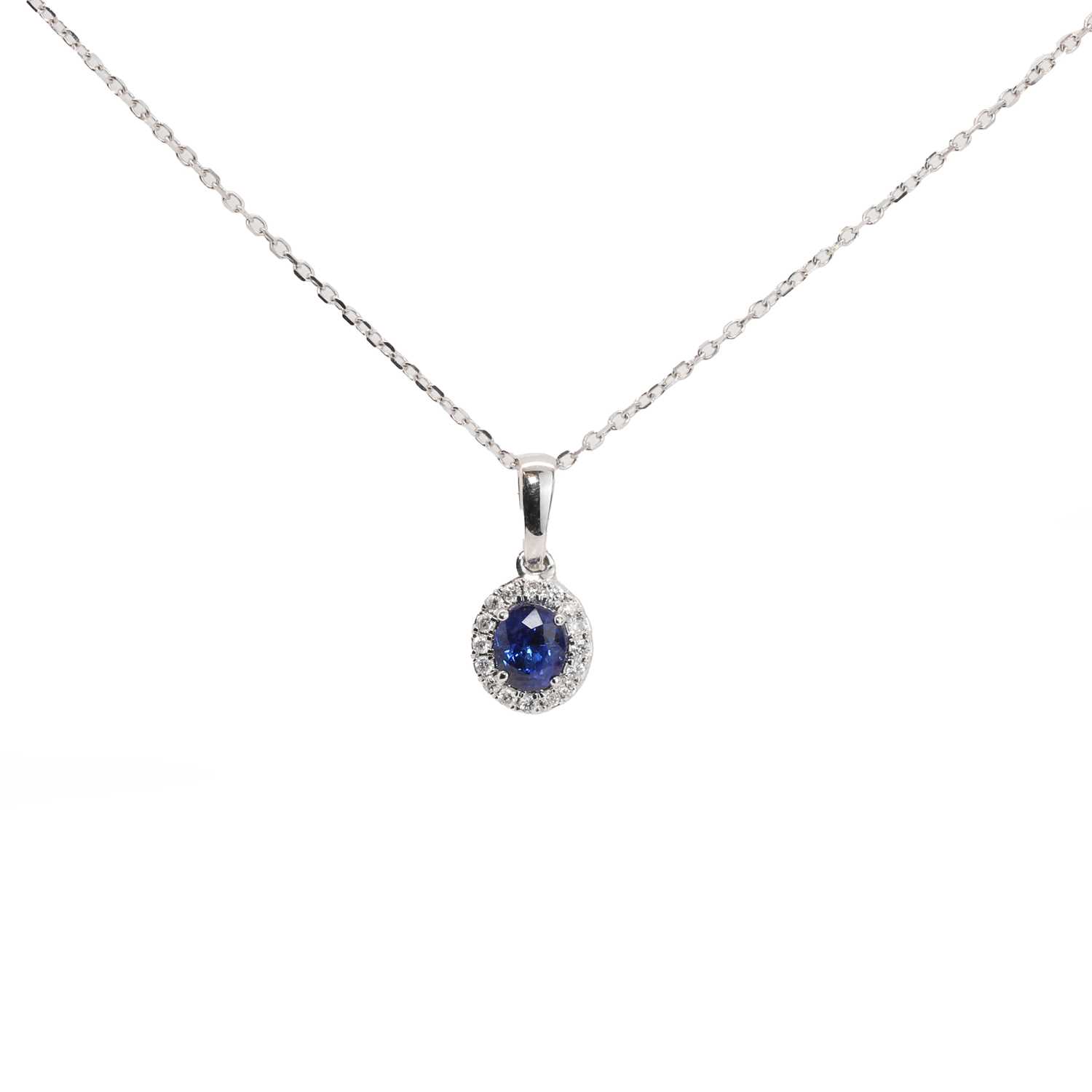 Lot 86 - A sapphire and diamond cluster pendant necklace