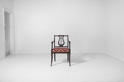 Lot 131 - A Regency ebonised and parcel-gilt wooden elbow chair