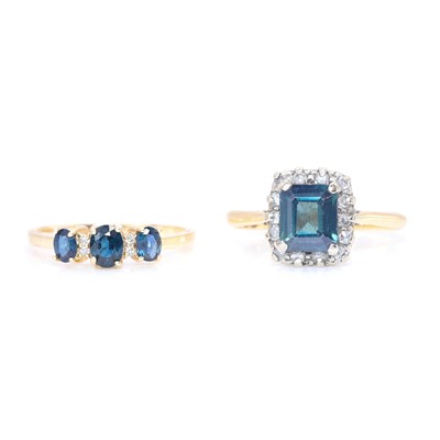 Lot 197 - An 18ct gold sapphire cluster ring and a sapphire three stone ring