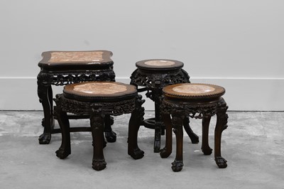 Lot 518 - A Chinese carved hardwood urn stand