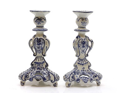 Lot 217 - A pair of Delft candlesticks