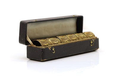 Lot 313 - A set of six brass napkin rings