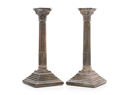 Lot 11 - A pair of silver Corinthian column candlesticks