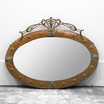 Lot 492 - A copper and brass Arts and Crafts oval wall mirror