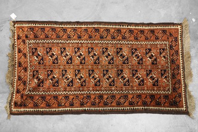 Lot 425 - A red ground Baluch rug