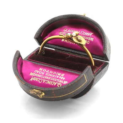 Lot 22 - An Art Nouveau pearl and diamond hinged bangle