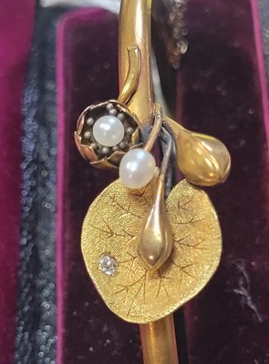 Lot 22 - An Art Nouveau pearl and diamond hinged bangle