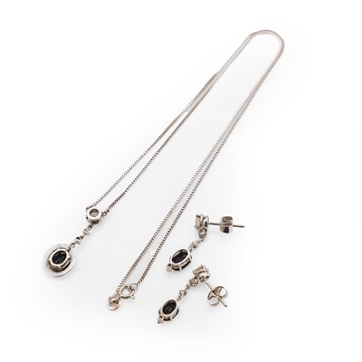 Lot 81 - A white gold sapphire and diamond pendant and drop earrings set