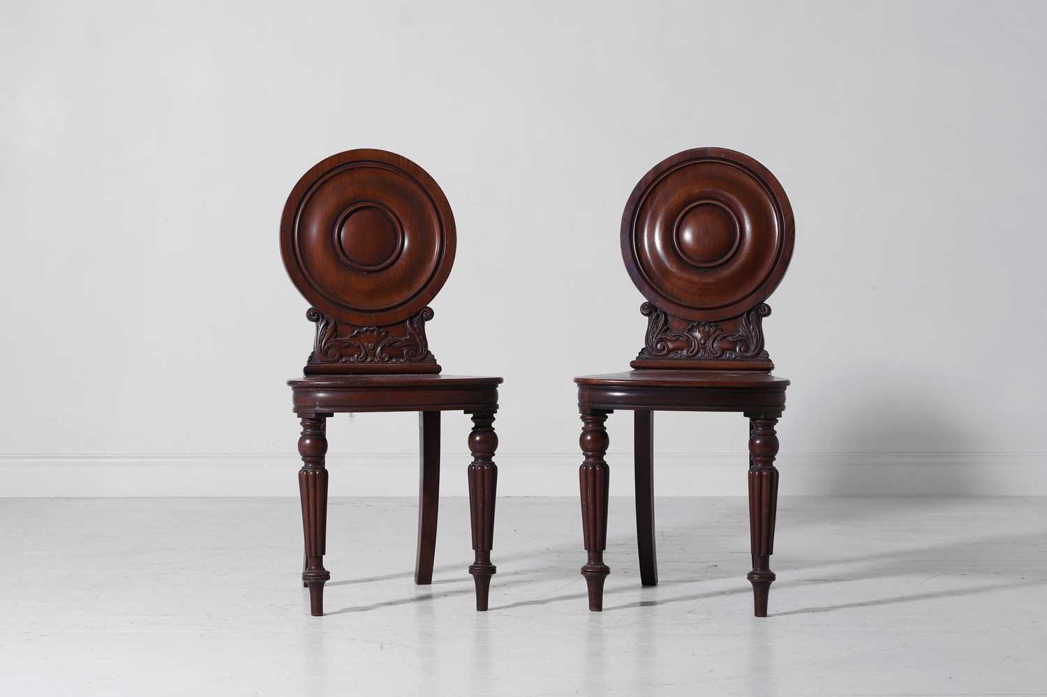 Lot 318 - A pair of Regency mahogany hall chairs