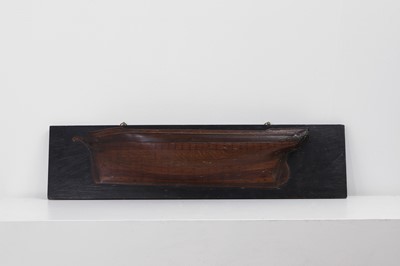 Lot 381 - A carved half-hull model of a ship