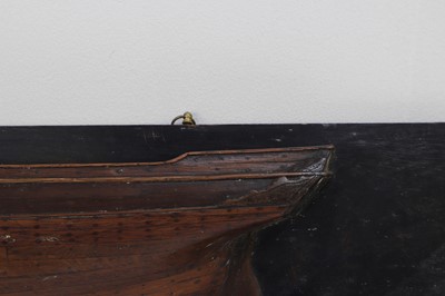 Lot 381 - A carved half-hull model of a ship