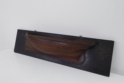 Lot 381 - A carved half-hull model of a ship