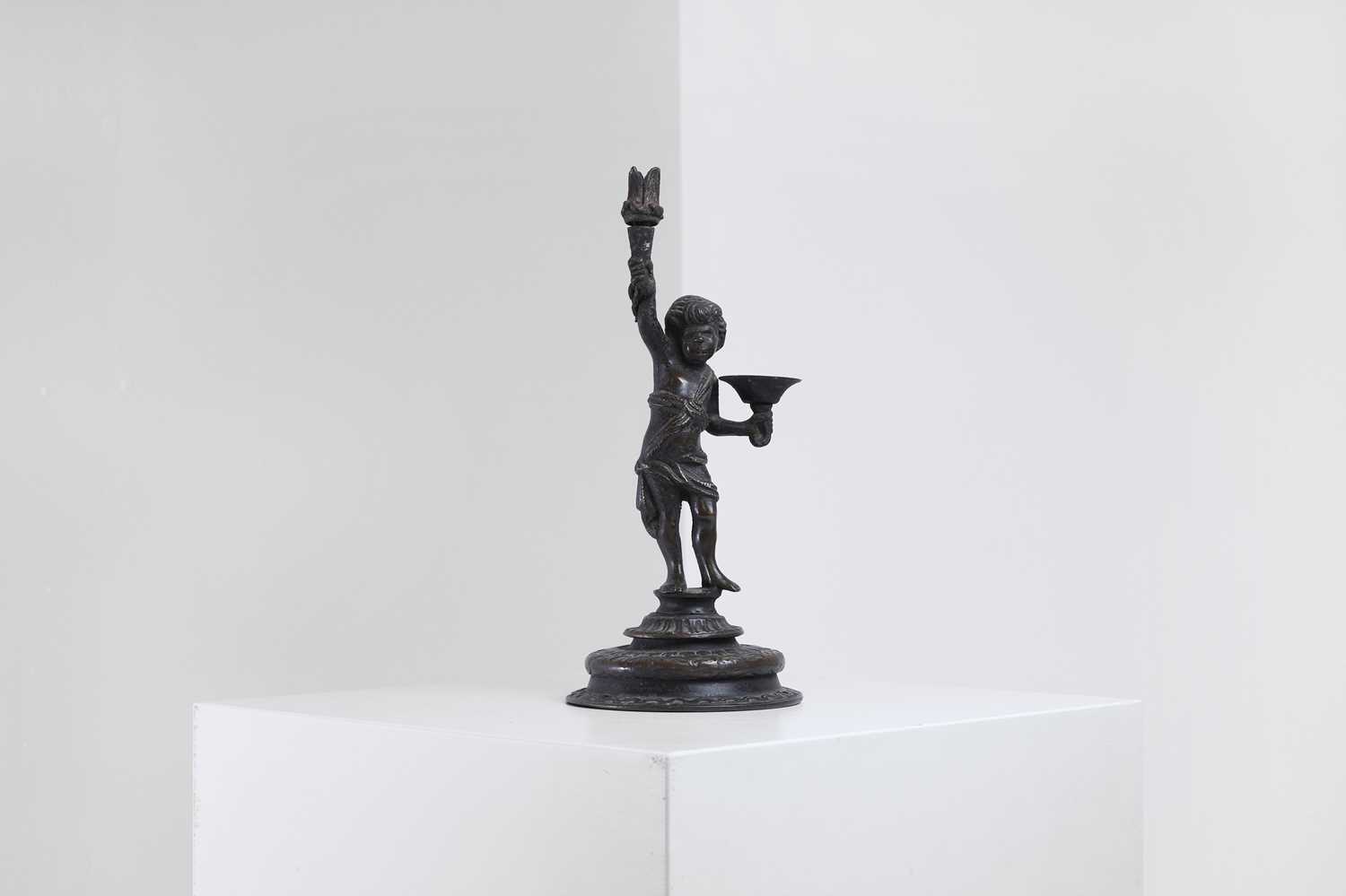 Lot 423 - A bronze figural candleholder