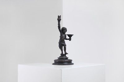 Lot 423 - A bronze figural candleholder