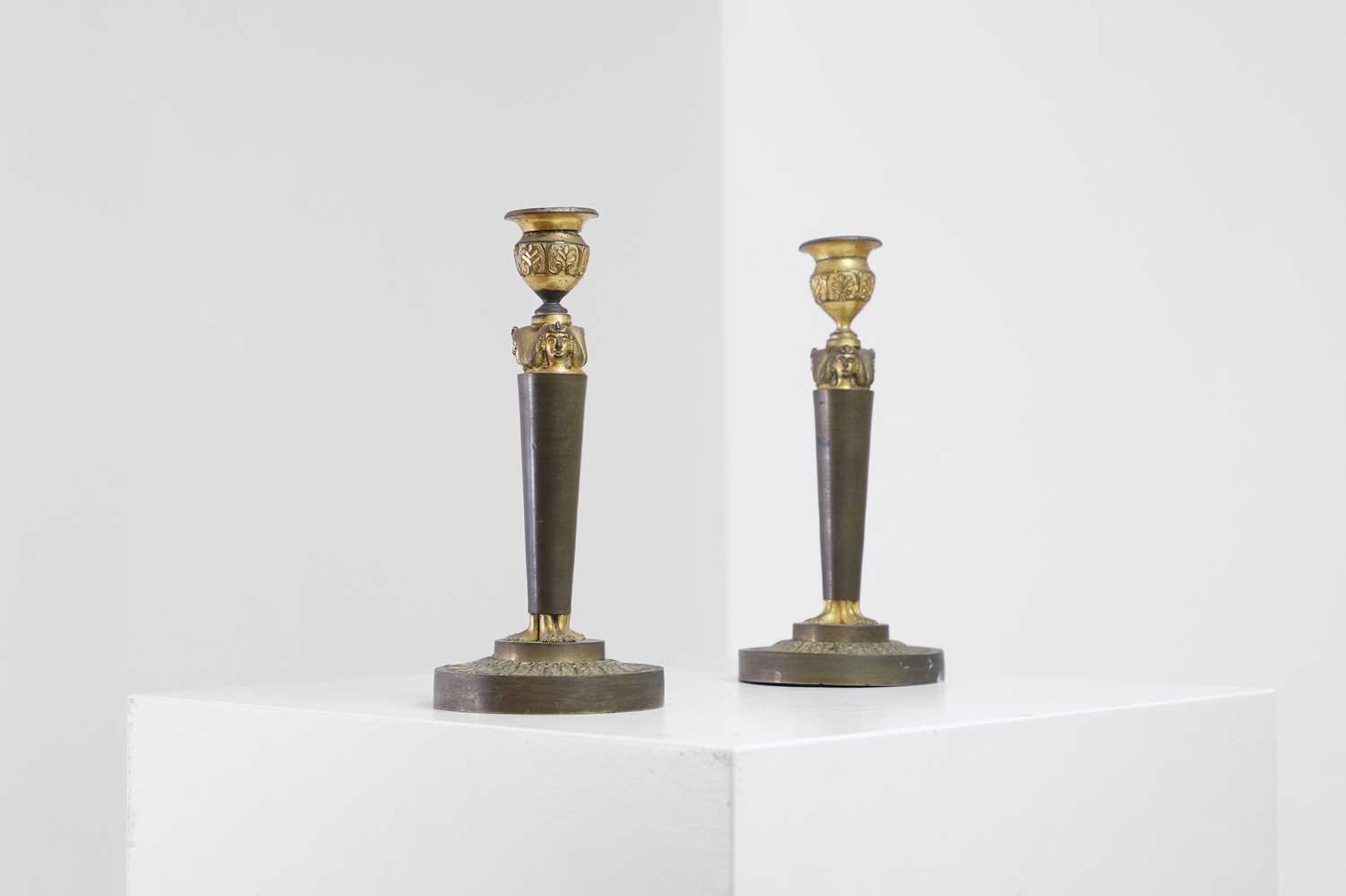 Lot 398 - A pair of neoclassical gilt-bronze candlesticks