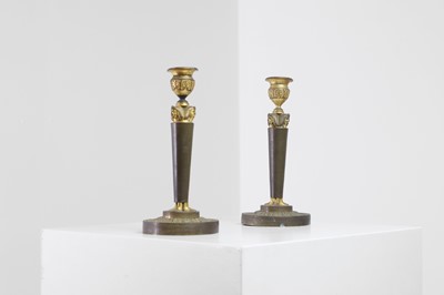 Lot 398 - A pair of neoclassical gilt-bronze candlesticks