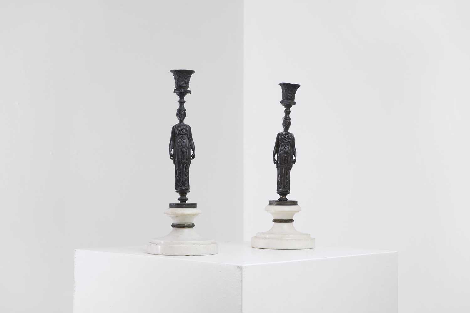 Lot 345 - A pair of neoclassical bronze and marble candlesticks
