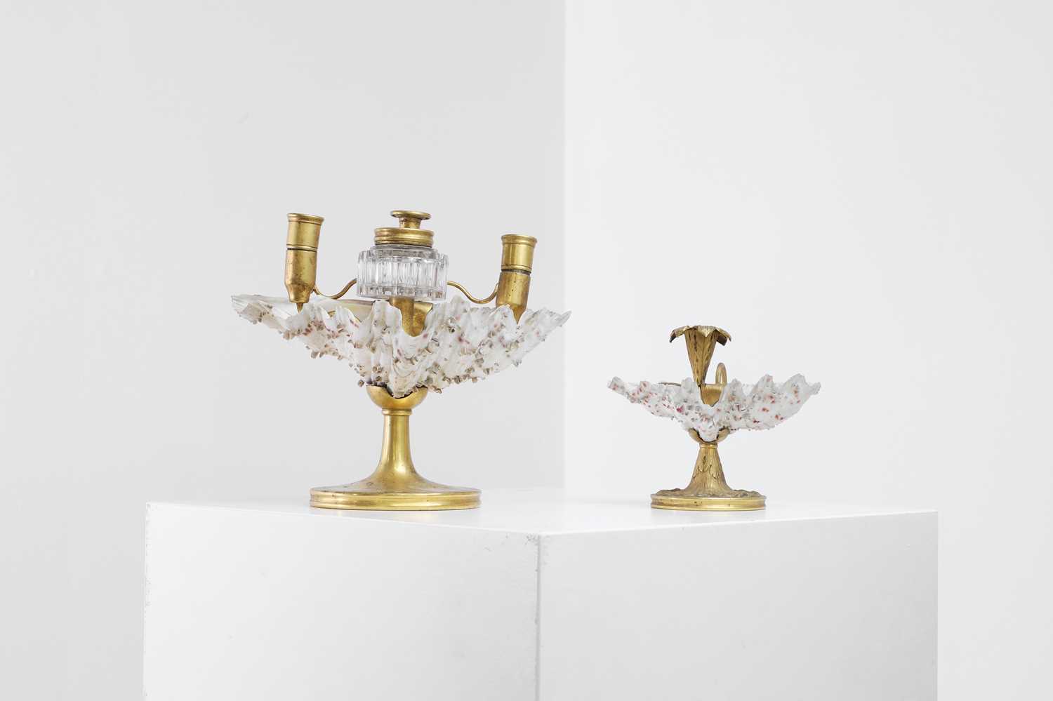 Lot 303 - Two Victorian shell and gilt-metal mounted chambersticks