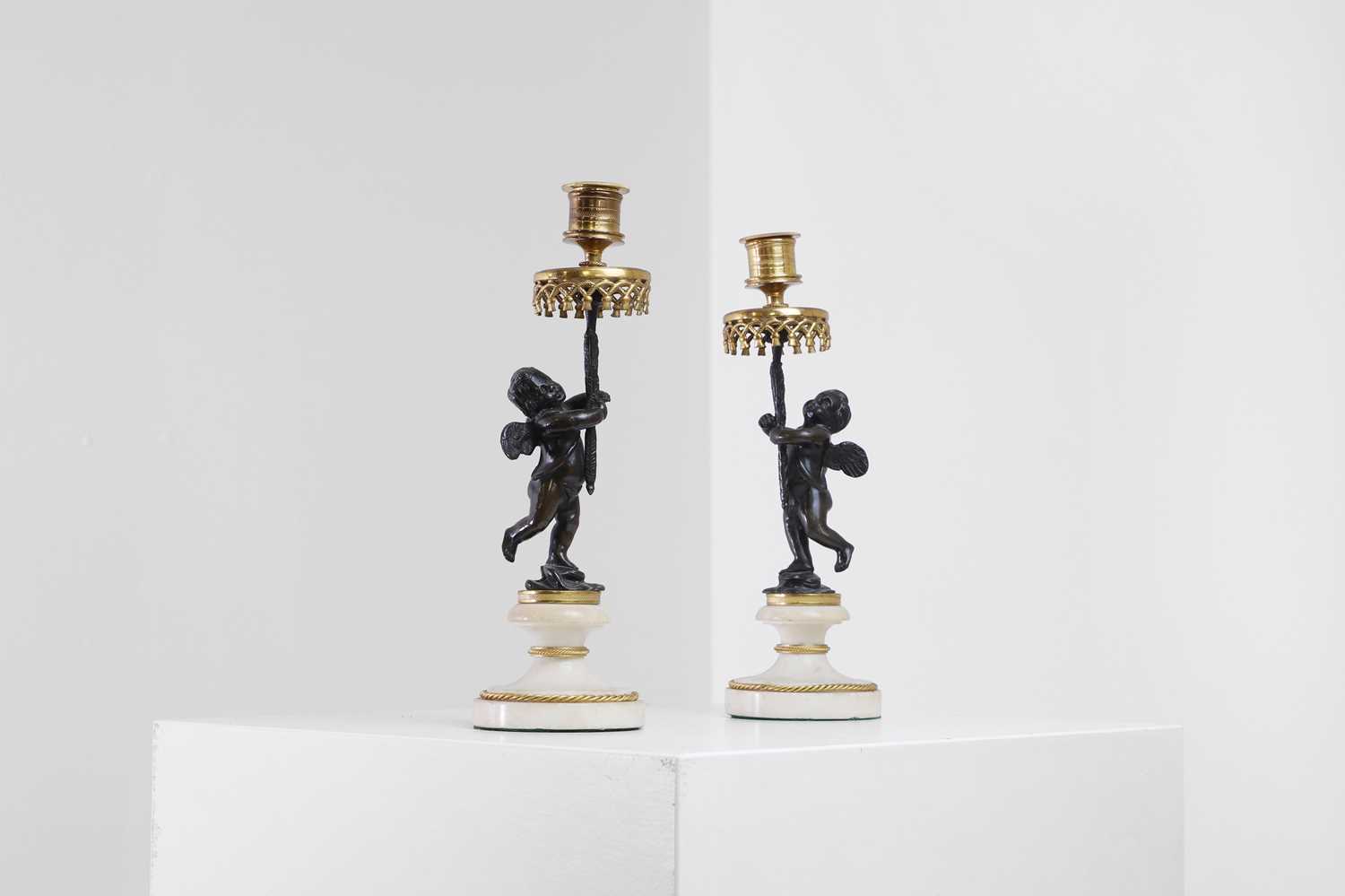 Lot 310 - A pair of Louis XVI-style ormolu, patinated bronze and marble candlesticks