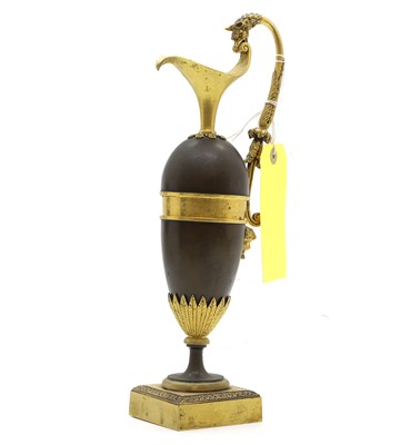 Lot 115 - A patinated and gilt bronze ewer